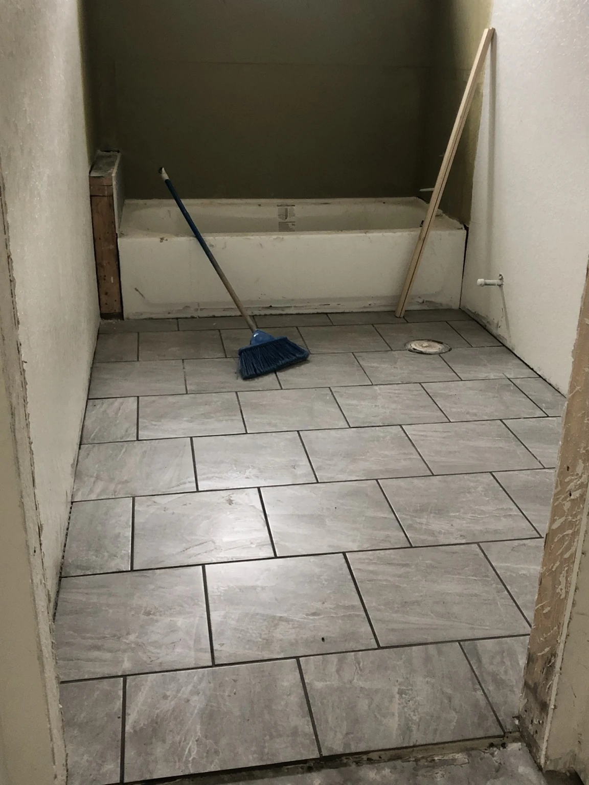 Separate bathroom tile flooring installation.