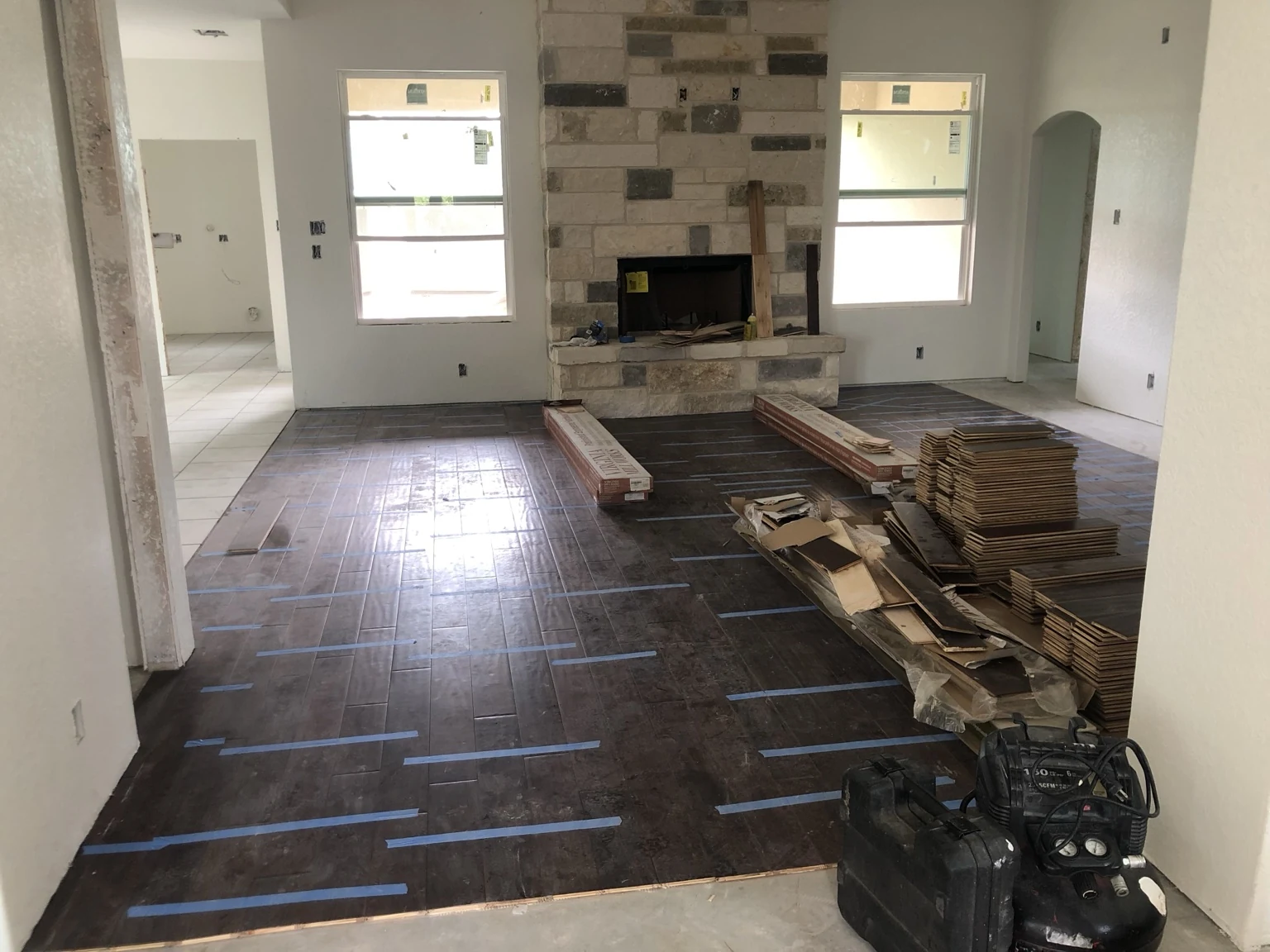 Custom-home flooring installation around the main living area and fireplace.