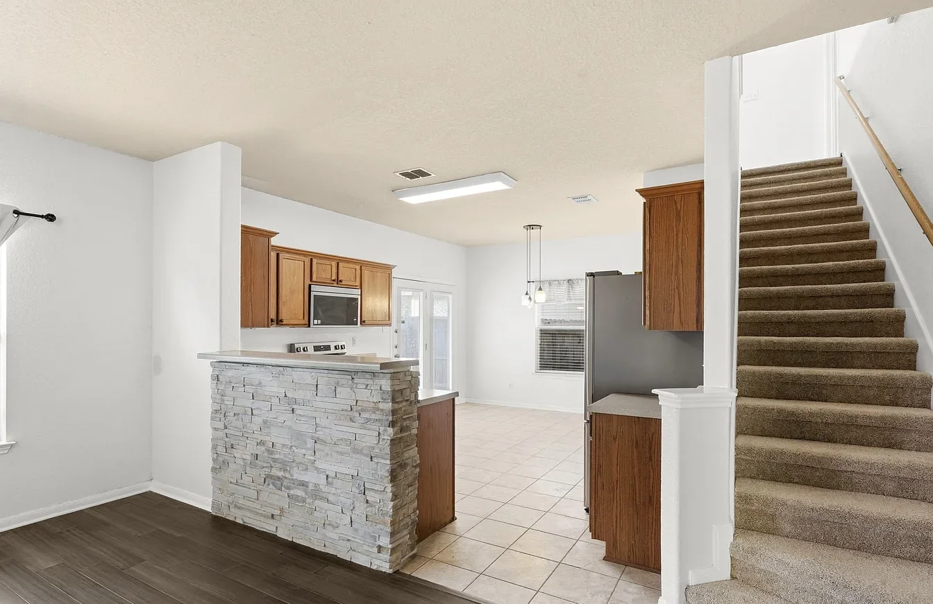 Cultured stone counter facade and bamboo flooring in the open living area.