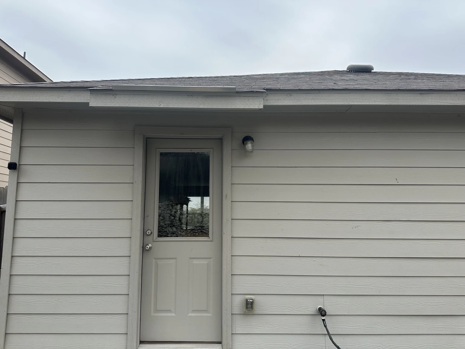 Before: the original rear-door condition prior to patio construction.