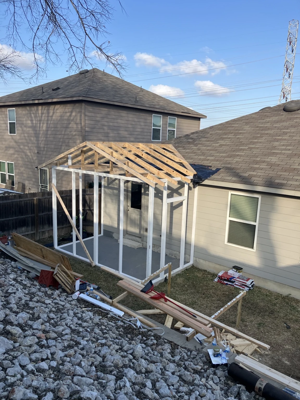 During: framing and roof structure taking shape at the rear of the home.