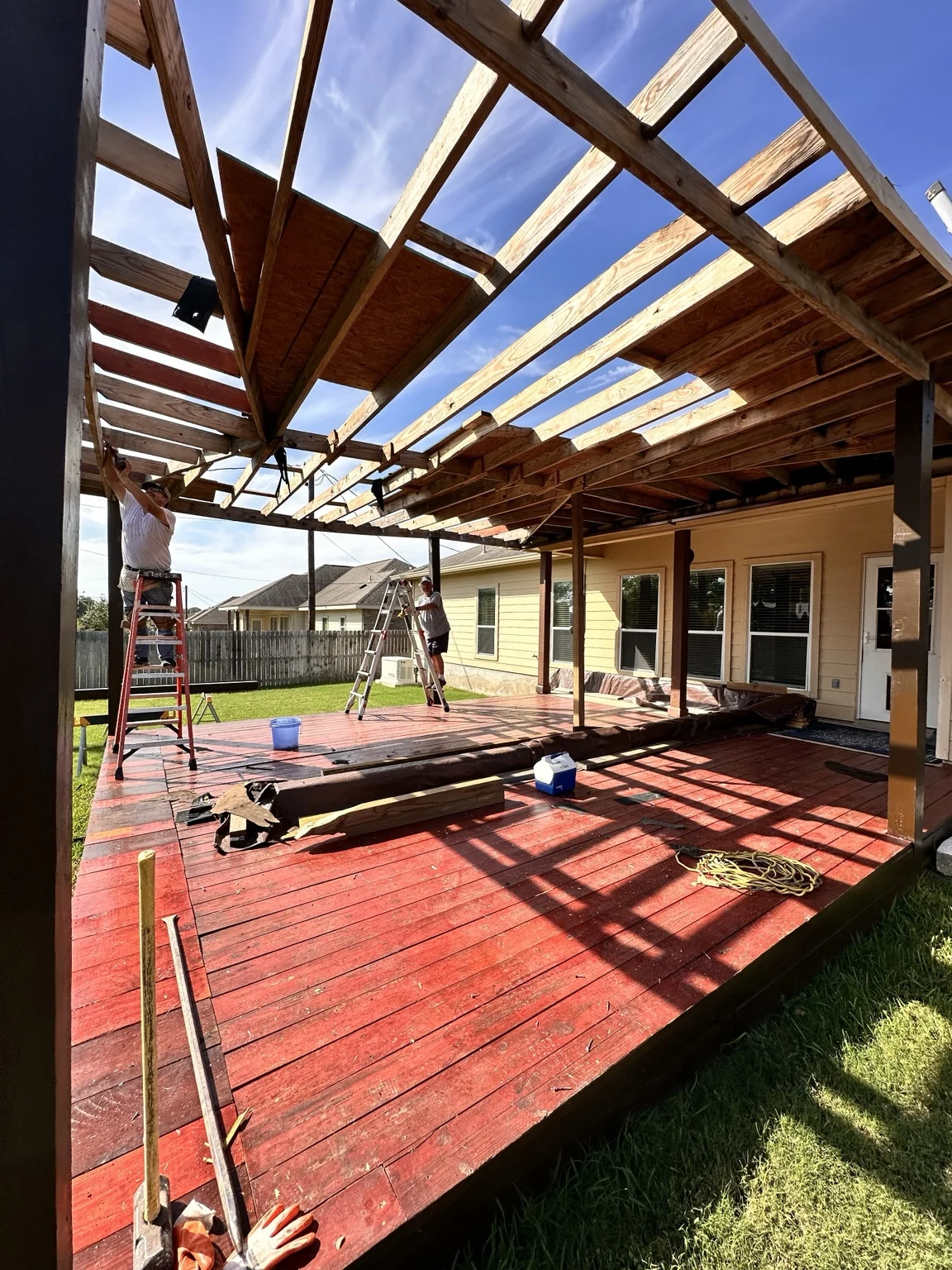 Roof reconstruction in progress above the salvaged deck.