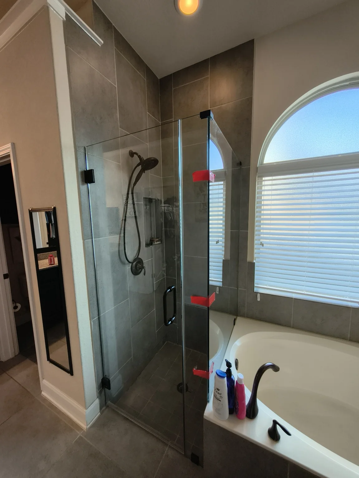 Installed custom frameless glass shower enclosure.