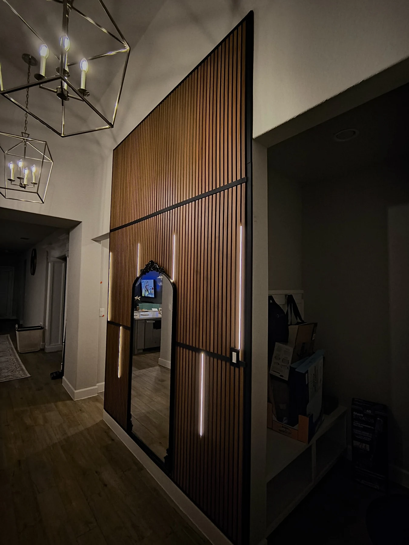 Additional custom slat-wall feature with integrated lighting and mirror detailing.