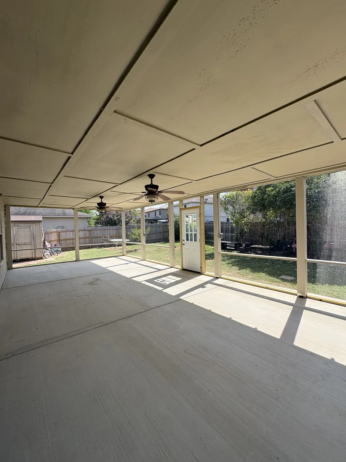 Interior view beneath the salvaged roof showing the completed screen system.