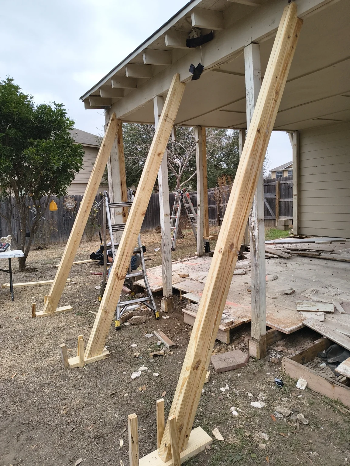 Temporary shoring and stabilization supporting the existing covered structure during repair.